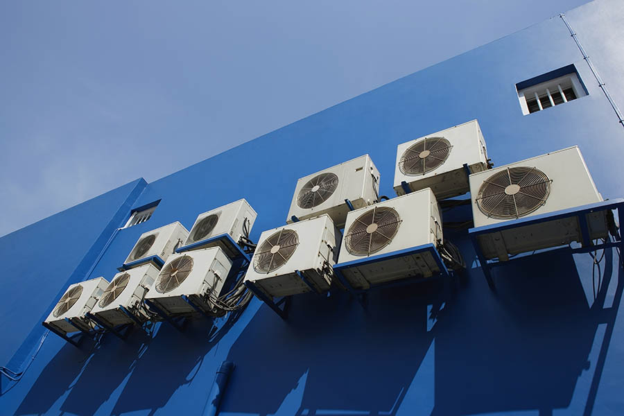 AC repair technician working on air conditioner