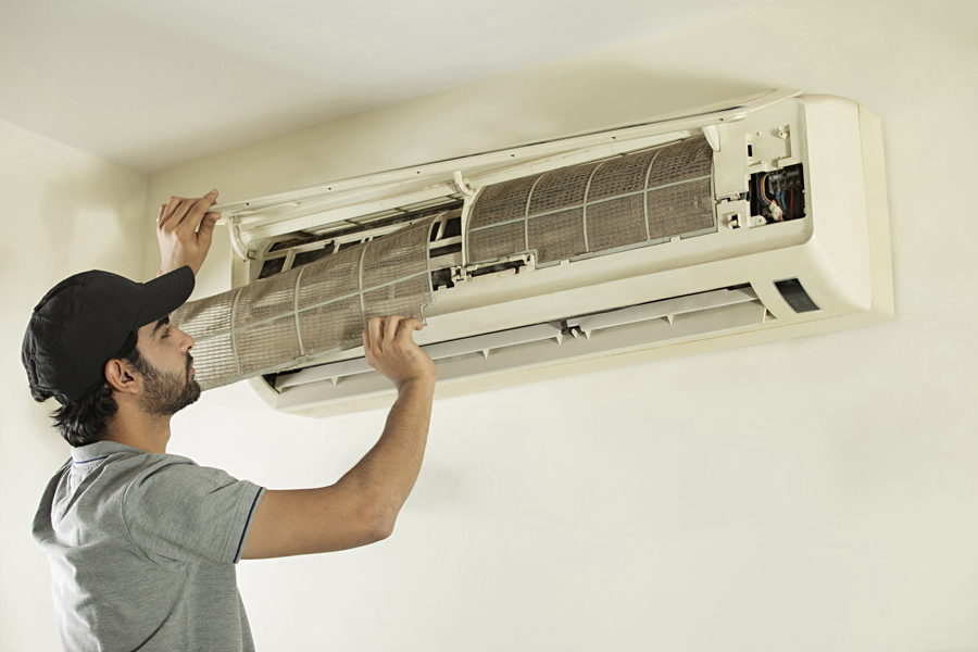 Technician repairing air conditioner unit